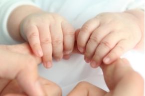 baby holding adult hand