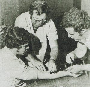 2.	Kaukauna Community Hospital anesthesiologist, Vern Horwitz, prepares EMT carl Vanevenoven’s arm as EMT Bruce Mathis prepares to stick it to Vanevenhoven. Courtesy Times Photo 7-26-1977.