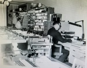 4. Kaukauna postal employees sorting mail at the Kaukauna Post Office located in the municipal building. Employee on left is Herman Schwin. Abt.1935.